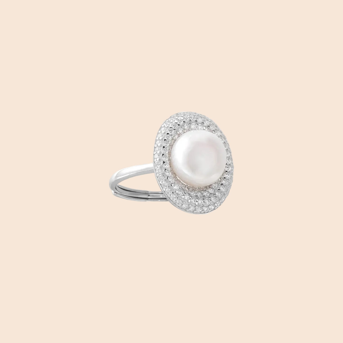 Silver ring with lustrous white pearl center surrounded by sparkling crystal halo on light background.