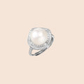 Rhodium-plated silver ring with round pearl center, double halo of baguette and round crystals forming cushion shape