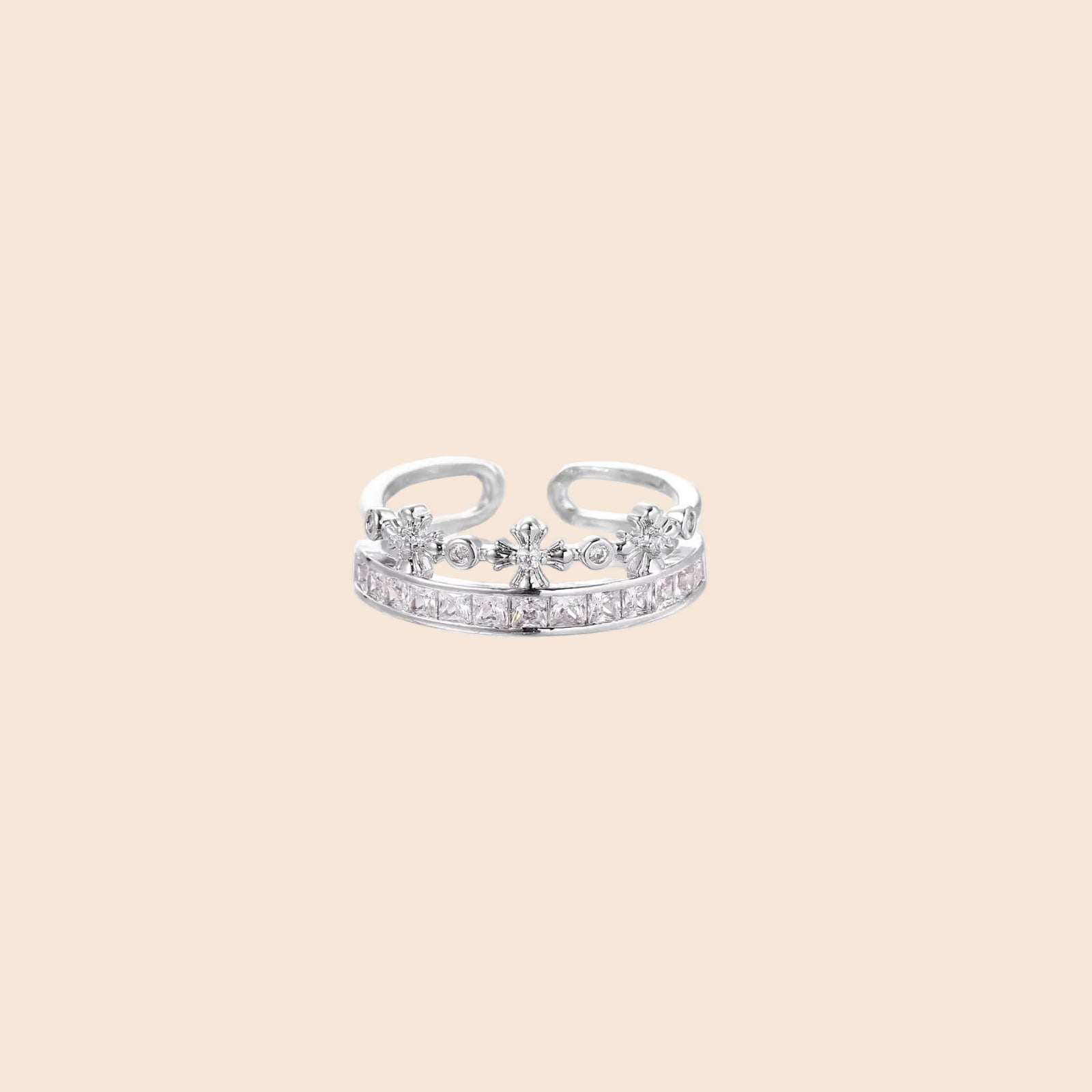 Silver-toned adjustable crown ring with channel-set square zirconia stones and delicate floral details on white background