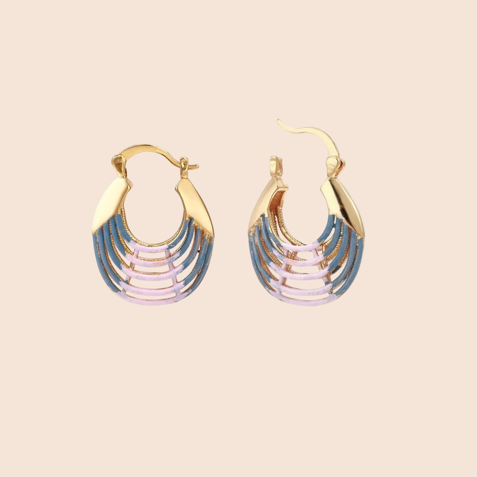 Gold hoop earrings with gradient blue-to-pink enamel in ribbed fan design on beige background