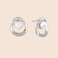 White gold-plated brass earrings with circular design, freshwater pearl center, and diamond accents
