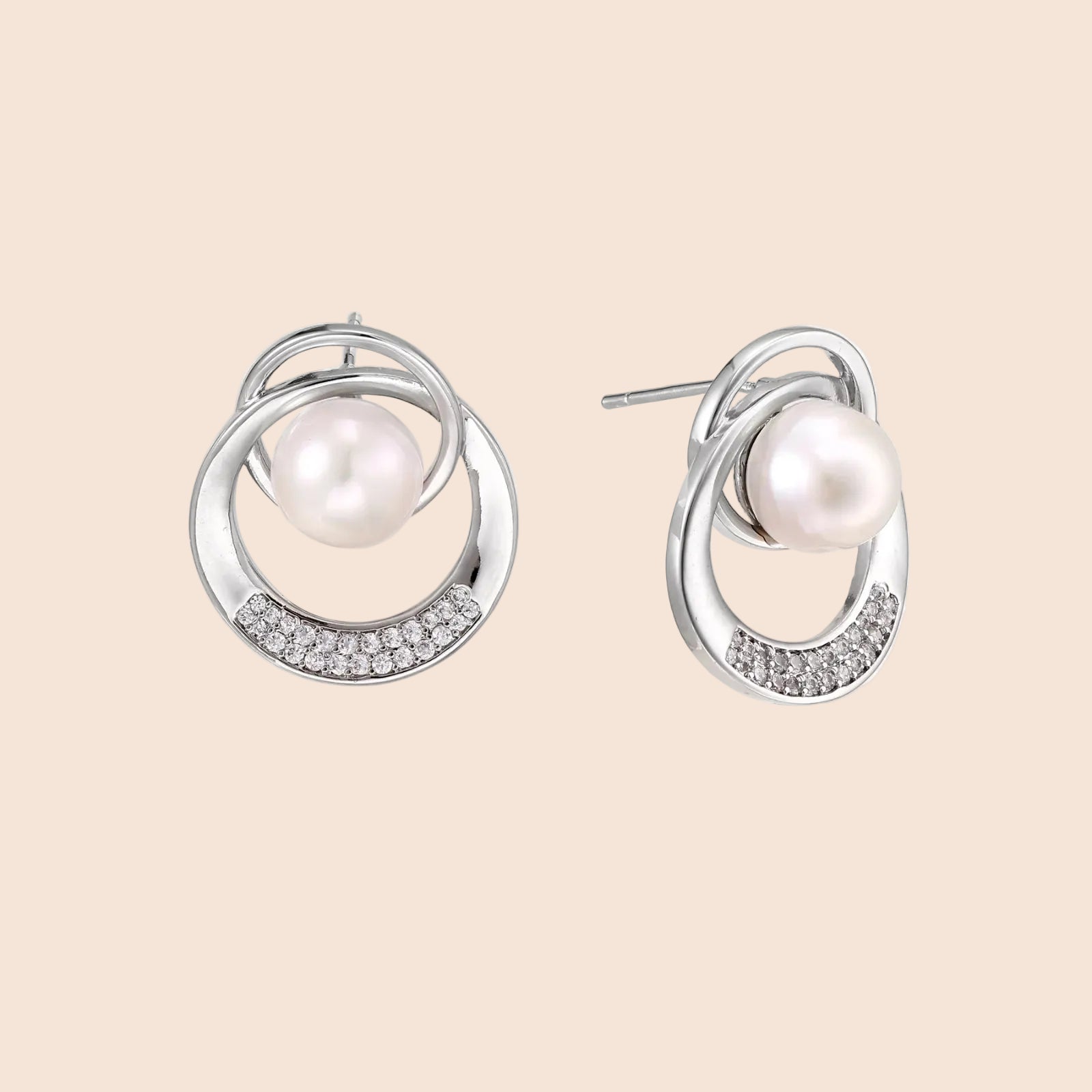 White gold-plated brass earrings with circular design, freshwater pearl center, and diamond accents