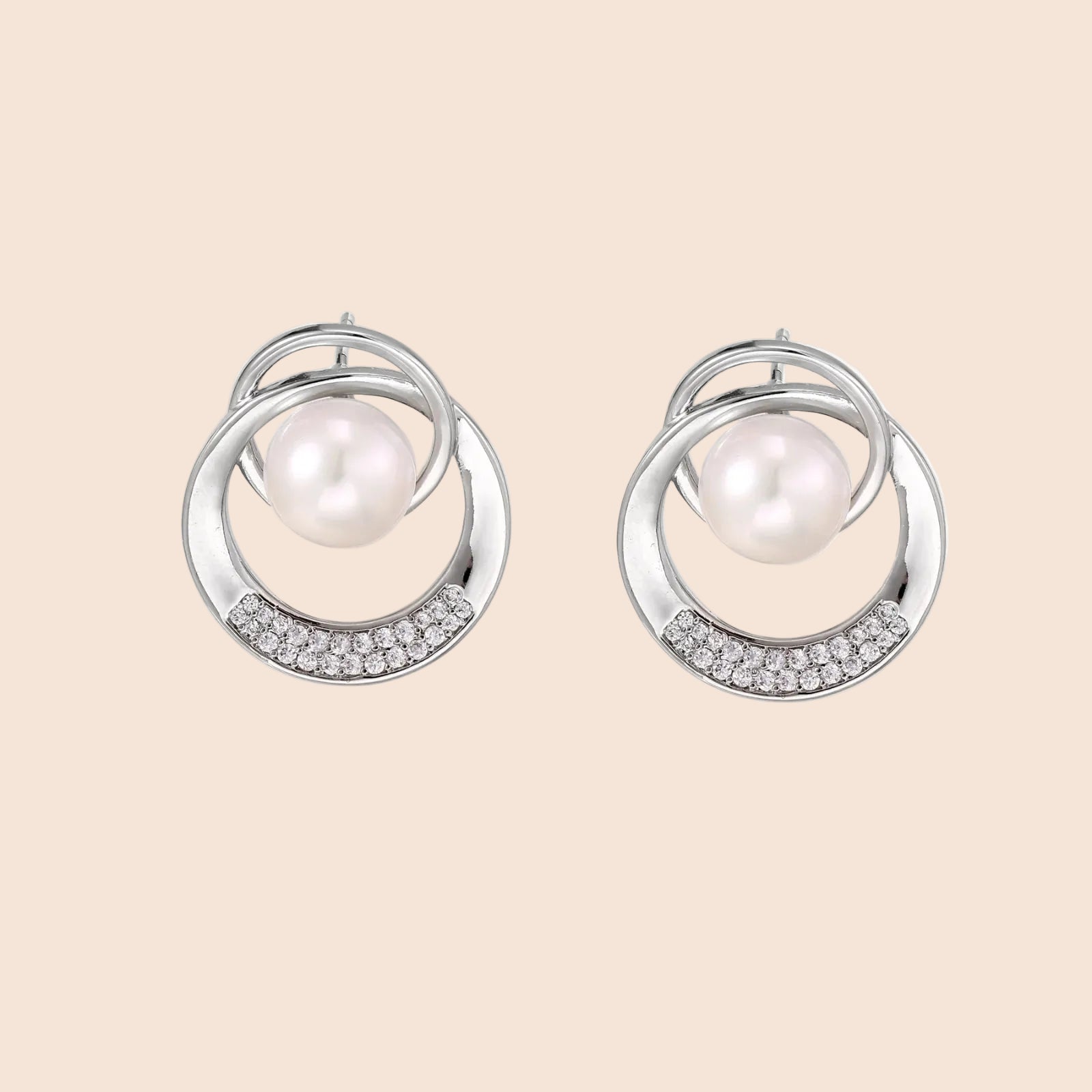 White gold-plated brass earrings with circular design, freshwater pearl center, and diamond accents