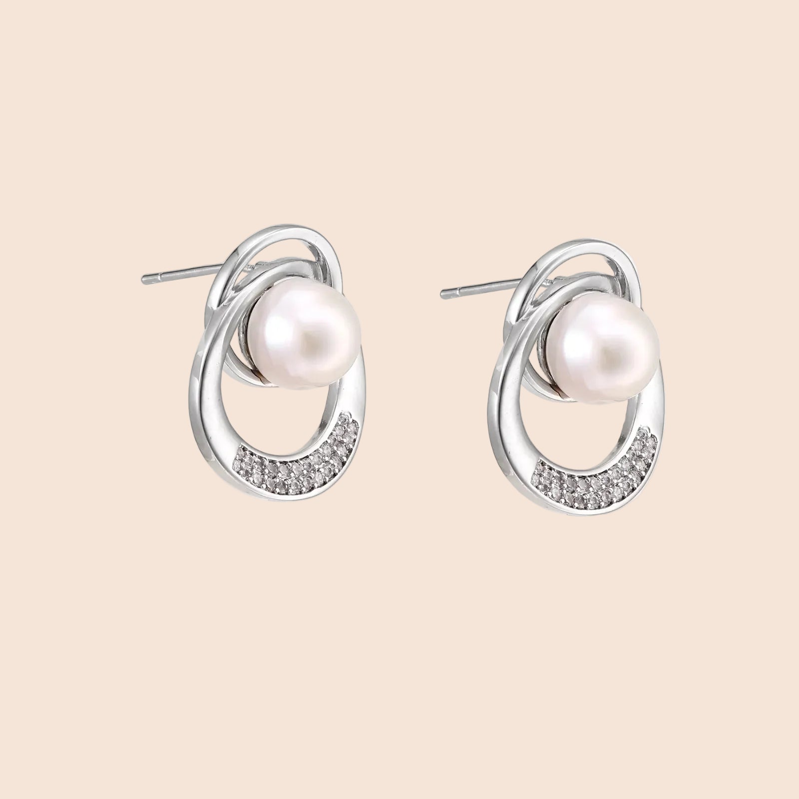 White gold-plated brass earrings with circular design, freshwater pearl center, and diamond accents