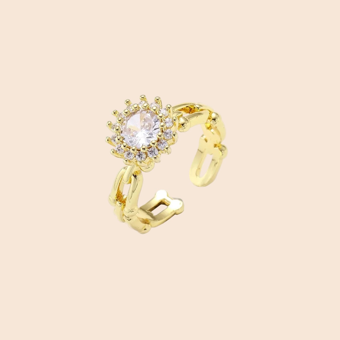 Two adjustable gold rings: chain-link band and halo-style ring with cubic zirconia stones on cream background