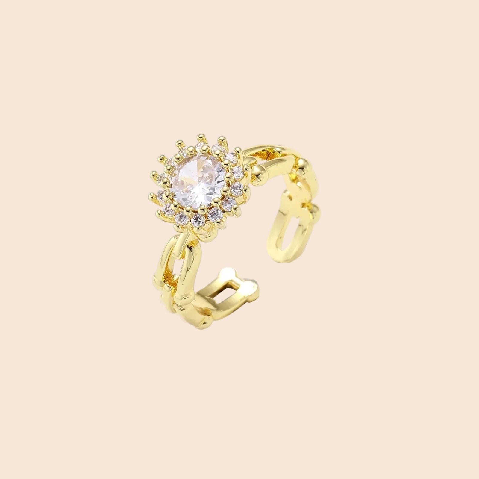 Two adjustable gold rings: chain-link band and halo-style ring with cubic zirconia stones on cream background