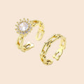 Two adjustable gold rings: chain-link band and halo-style ring with cubic zirconia stones on cream background