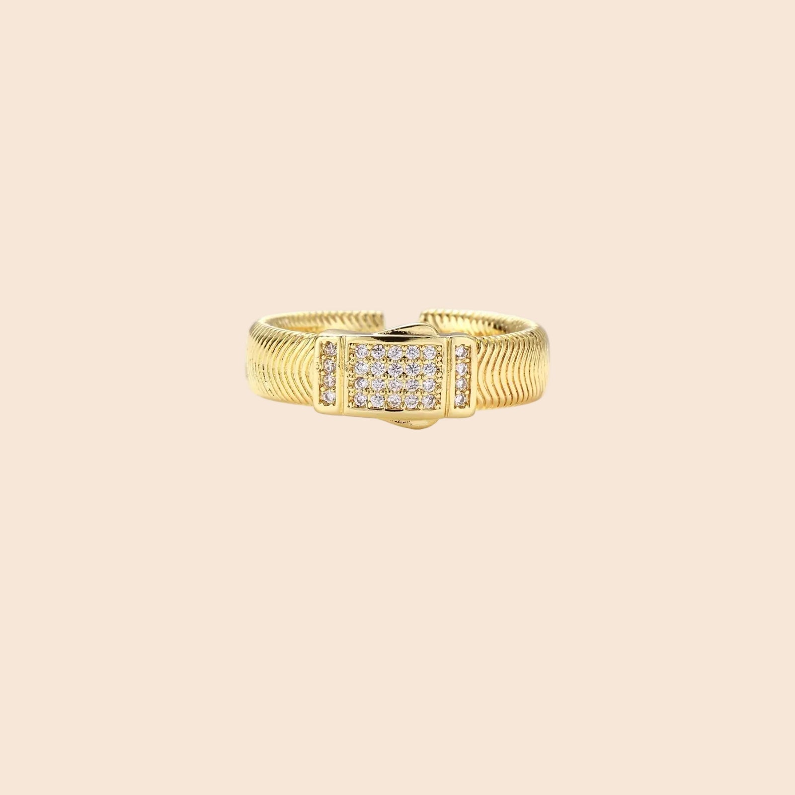 Gold-plated adjustable ring with ribbed band and rectangular pavé cubic zirconia panel on white background.