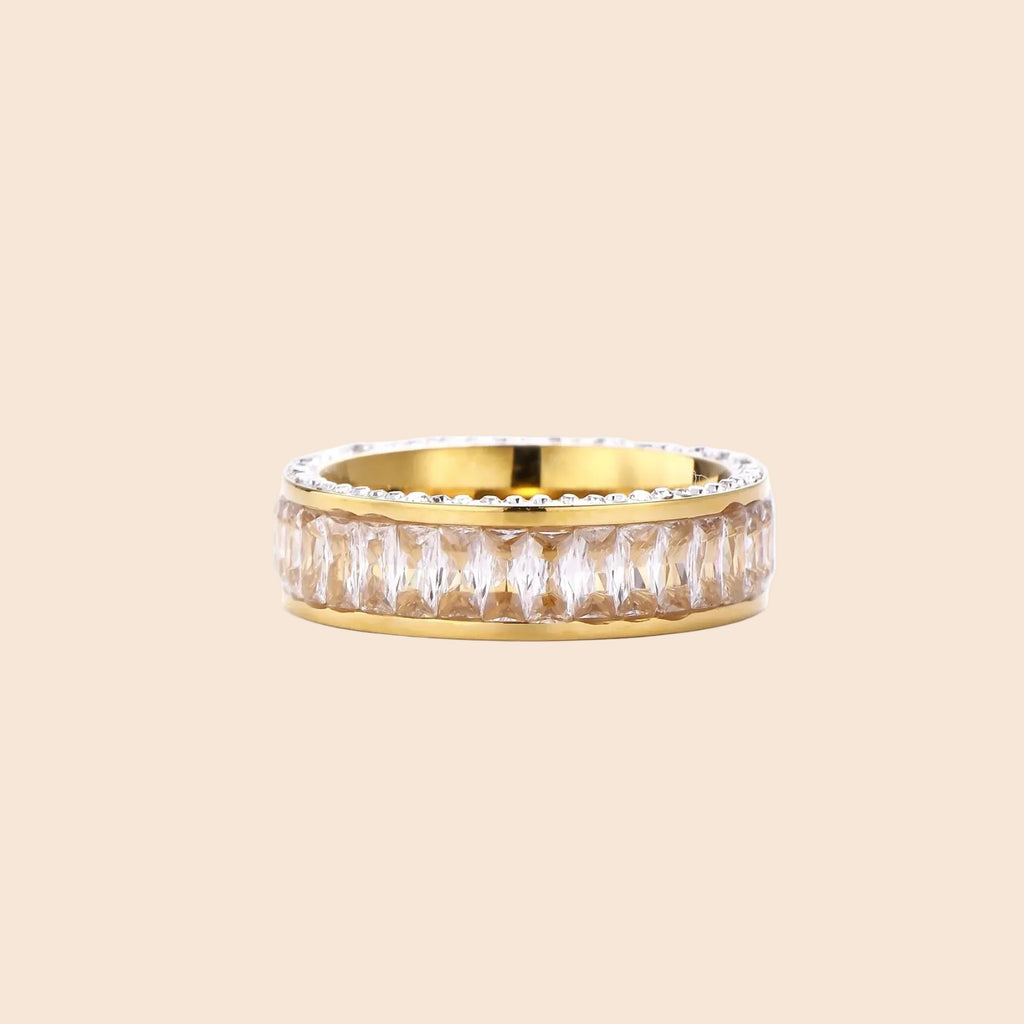 14K gold-plated ring with dual rows of clear baguette and round zirconia stones on cream background.
