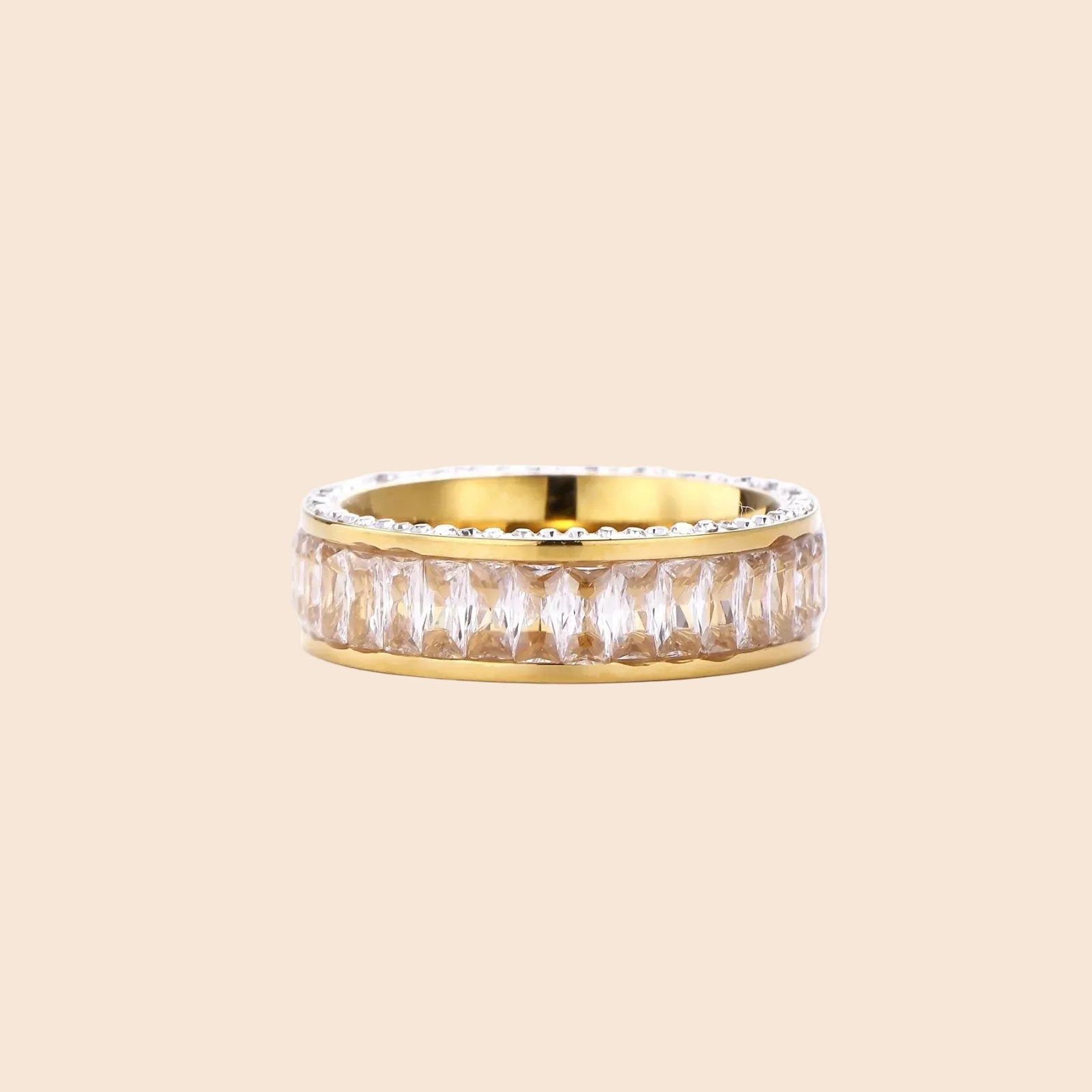 14K gold-plated ring with dual rows of clear baguette and round zirconia stones on cream background.