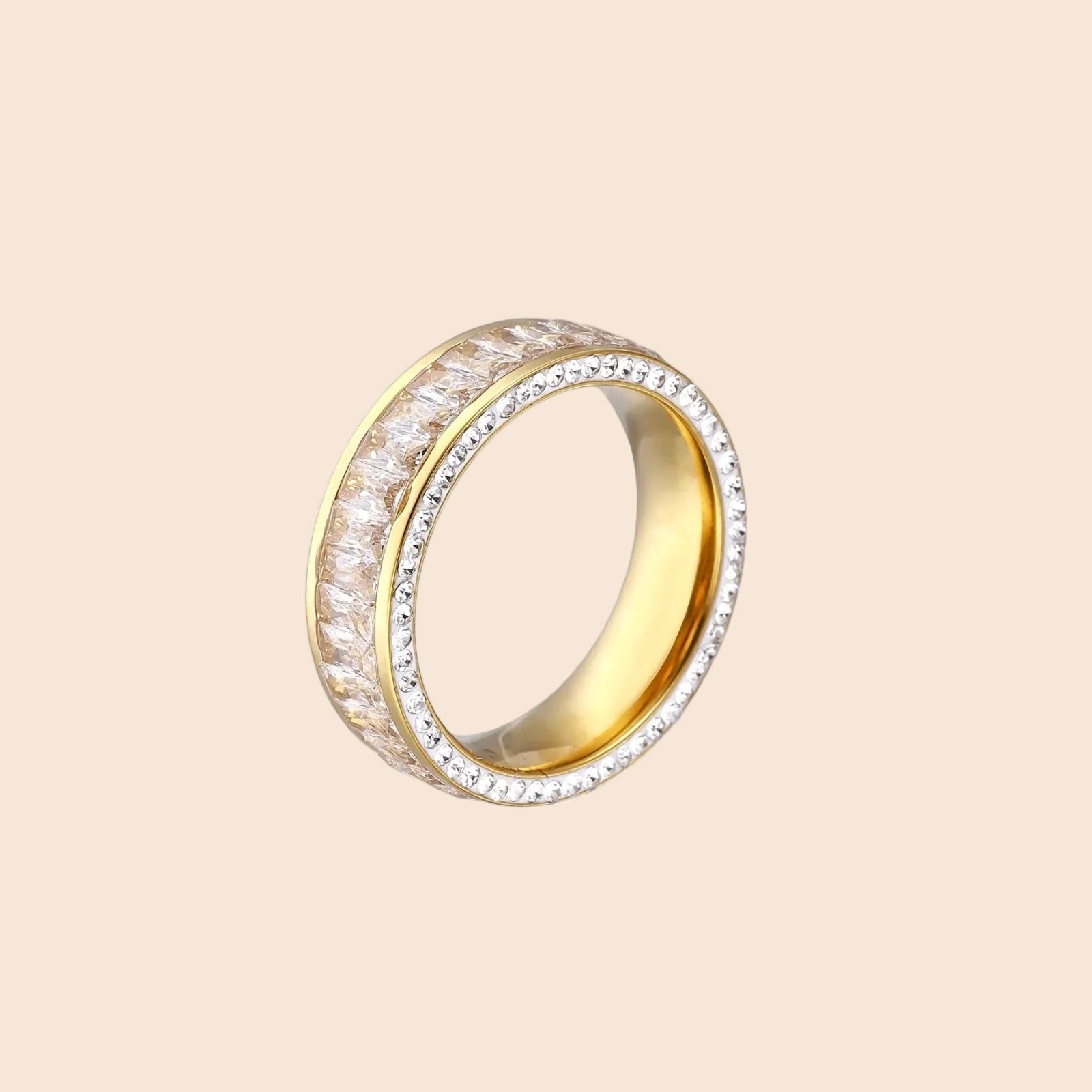 14K gold-plated ring with dual rows of clear baguette and round zirconia stones on cream background.