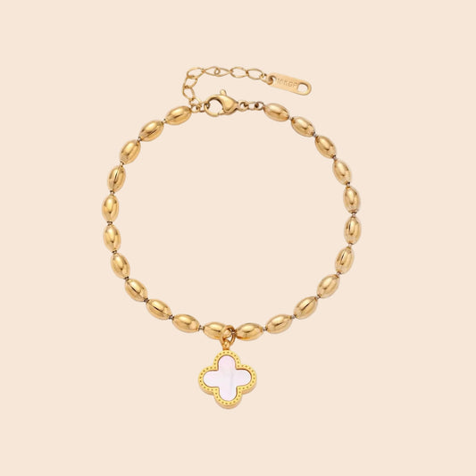 18K gold-plated oval bead chain bracelet with quatrefoil clover charm featuring mother of pearl inlay on cream background