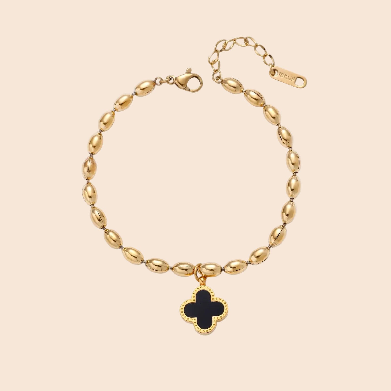 18K gold-plated oval bead chain bracelet with quatrefoil clover charm featuring mother of pearl inlay on cream background