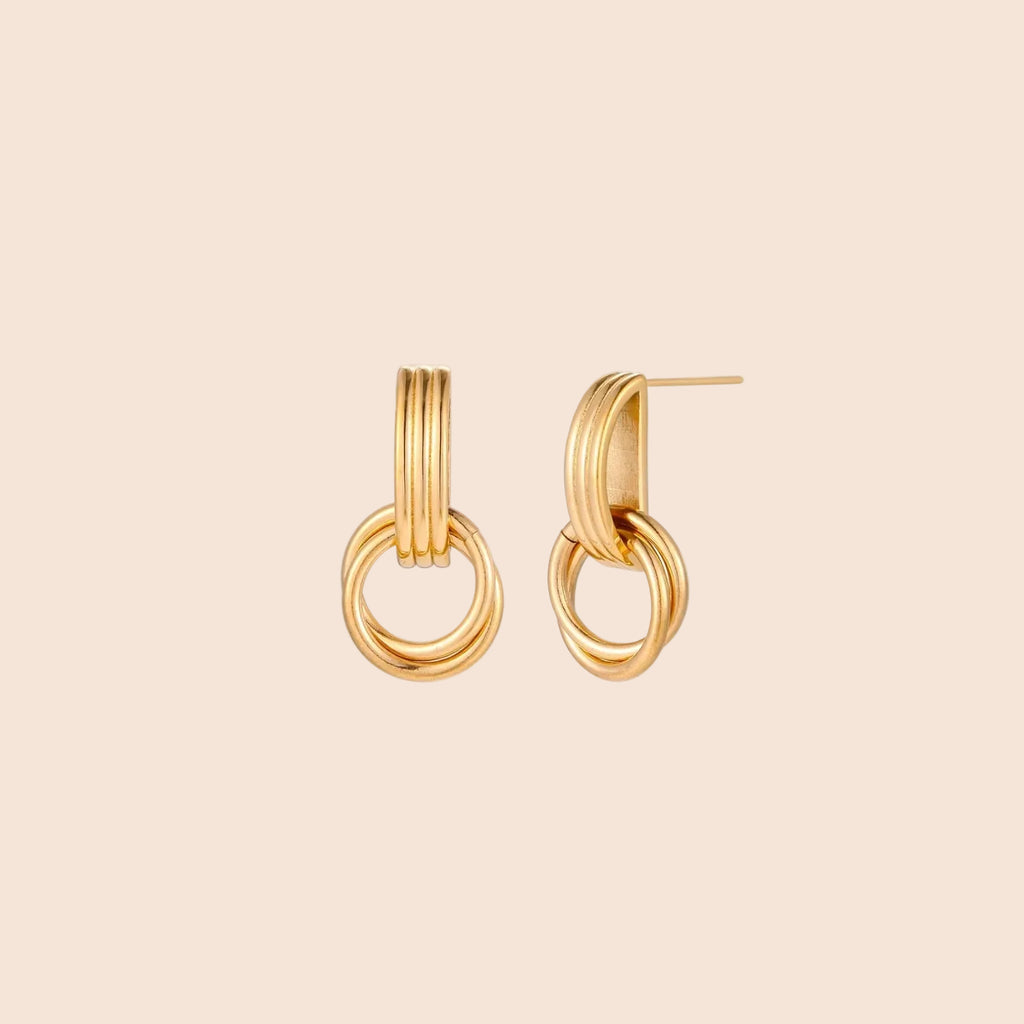 Gold stud earrings with vertical ridged bar connecting to triple interlocking circular rings on white background