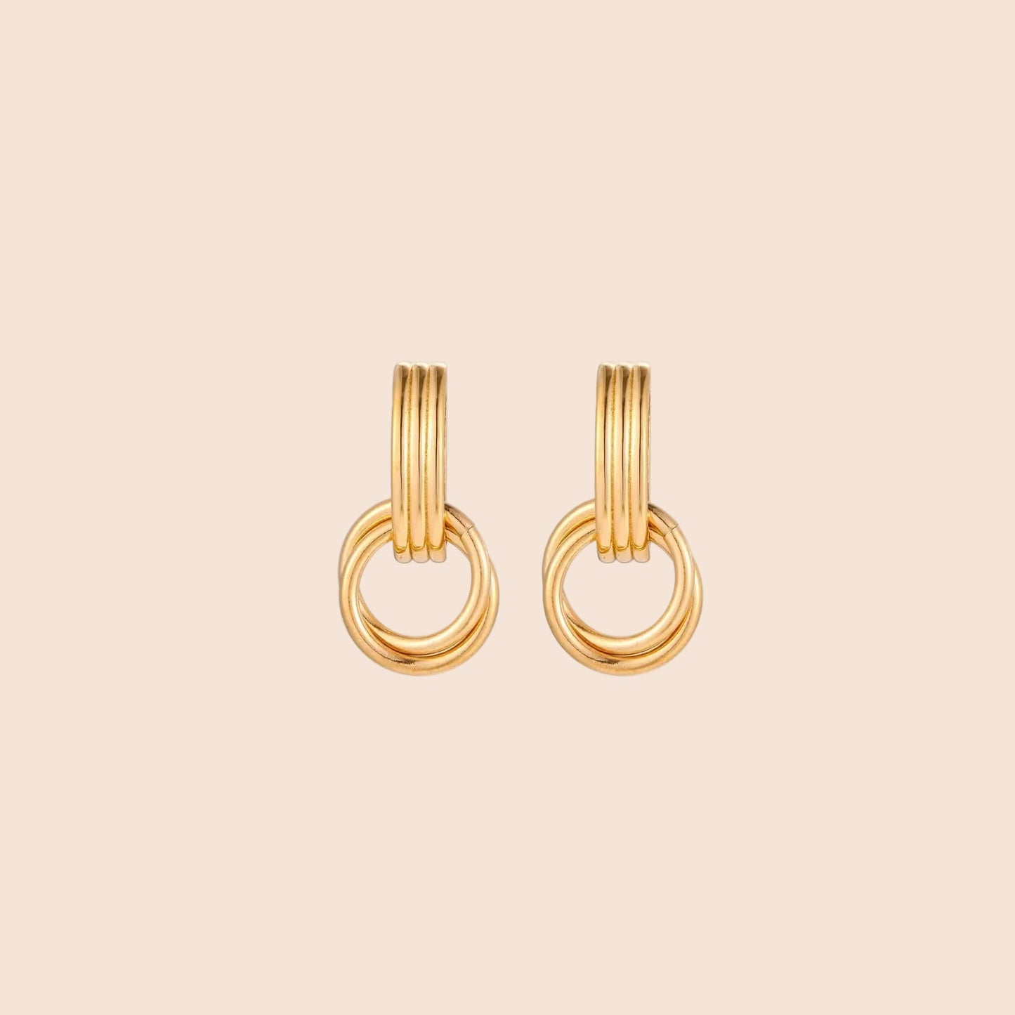 Gold stud earrings with vertical ridged bar connecting to triple interlocking circular rings on white background