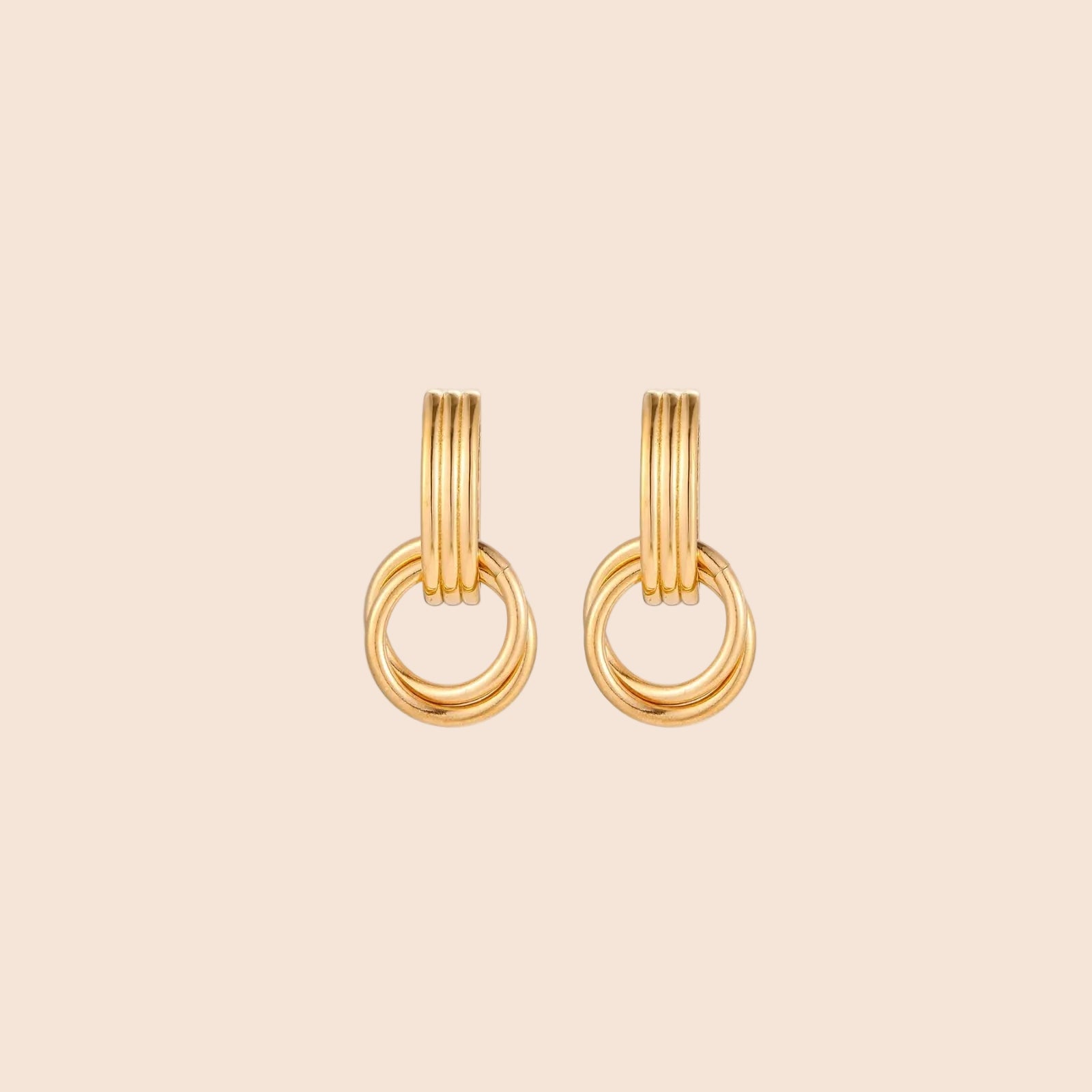 Gold stud earrings with vertical ridged bar connecting to triple interlocking circular rings on white background
