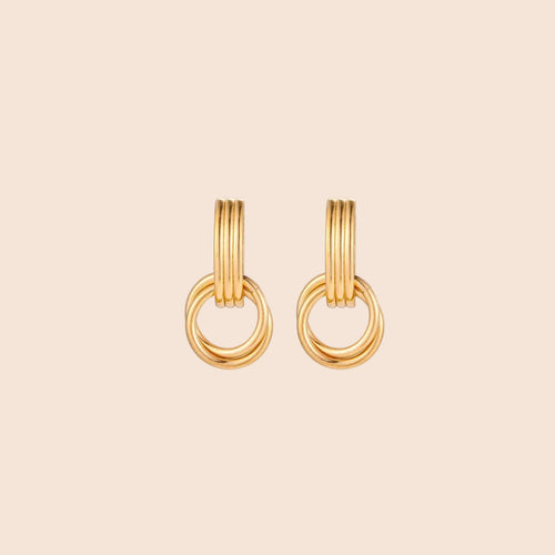 Gold stud earrings with vertical ridged bar connecting to triple interlocking circular rings on white background