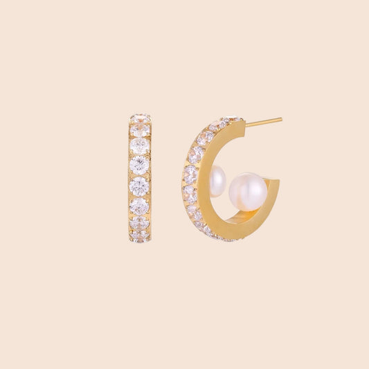 Gold pavé hoop earrings with two freshwater pearls nestled inside the curved design, featuring crystal-studded outer edge.