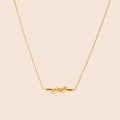 Dainty 18K gold plated necklace with infinity knot pendant on delicate chain against white background