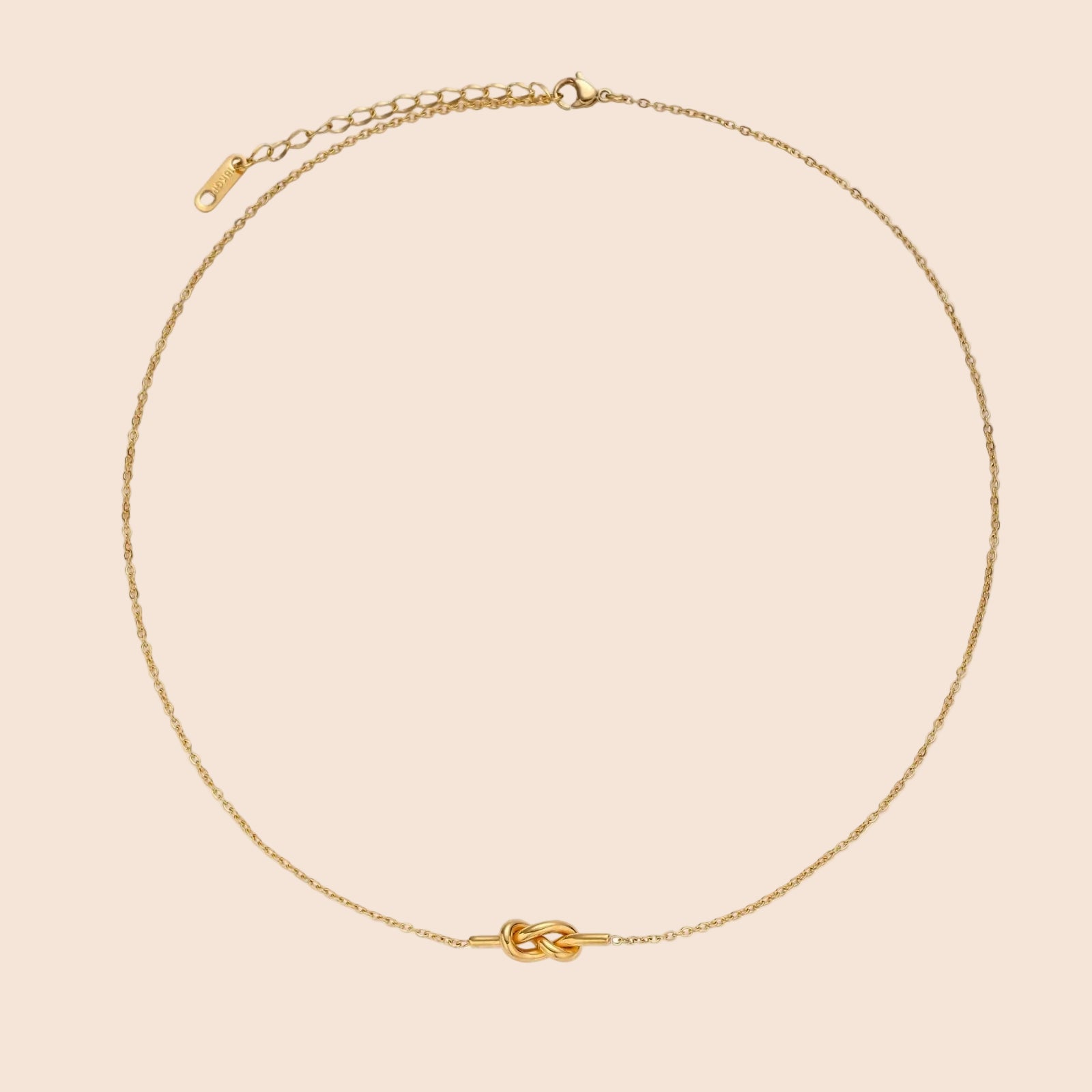 Dainty 18K gold plated necklace with infinity knot pendant on delicate chain against white background