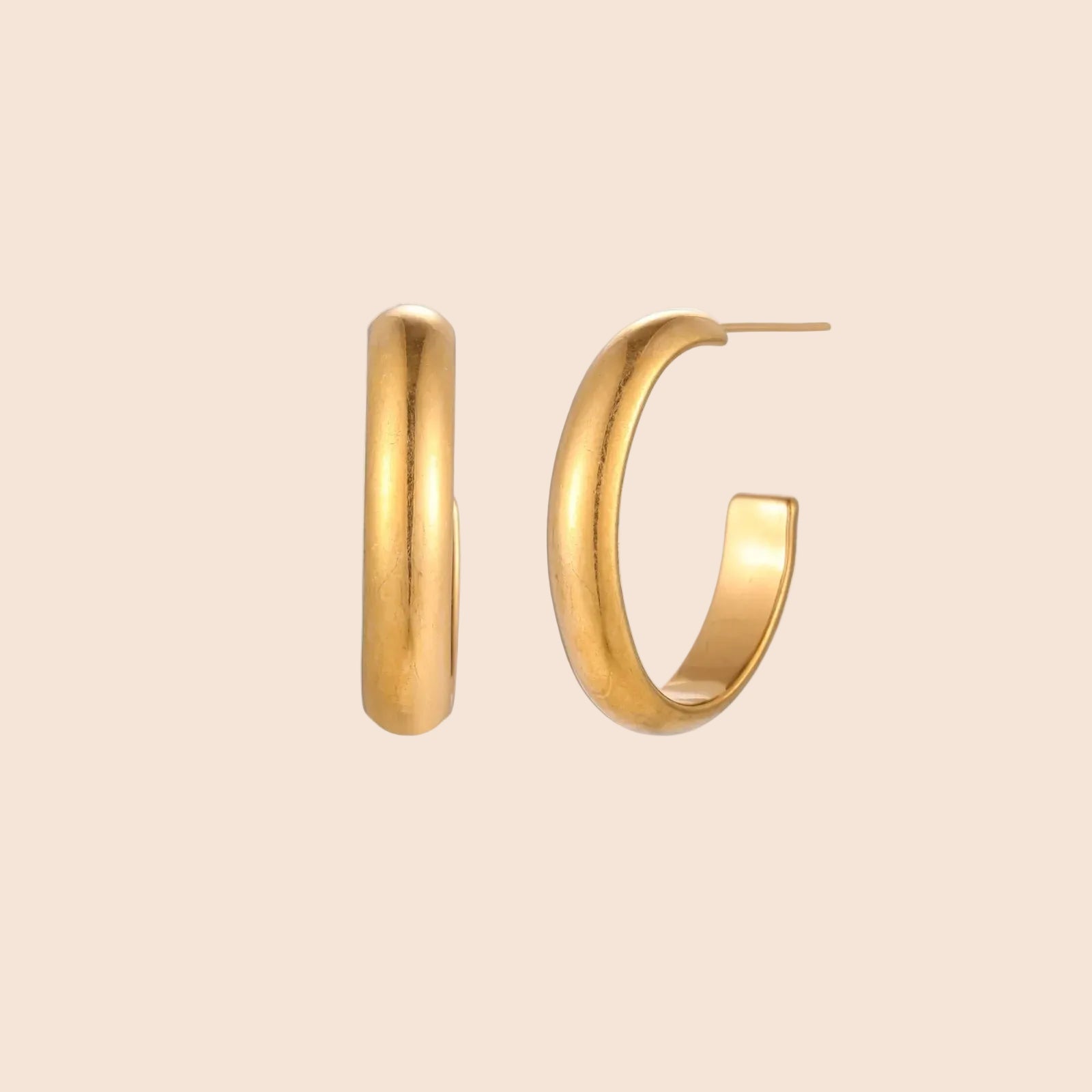 Chunky brushed gold hoop earrings in 14K plated stainless steel on cream background, front and side view.