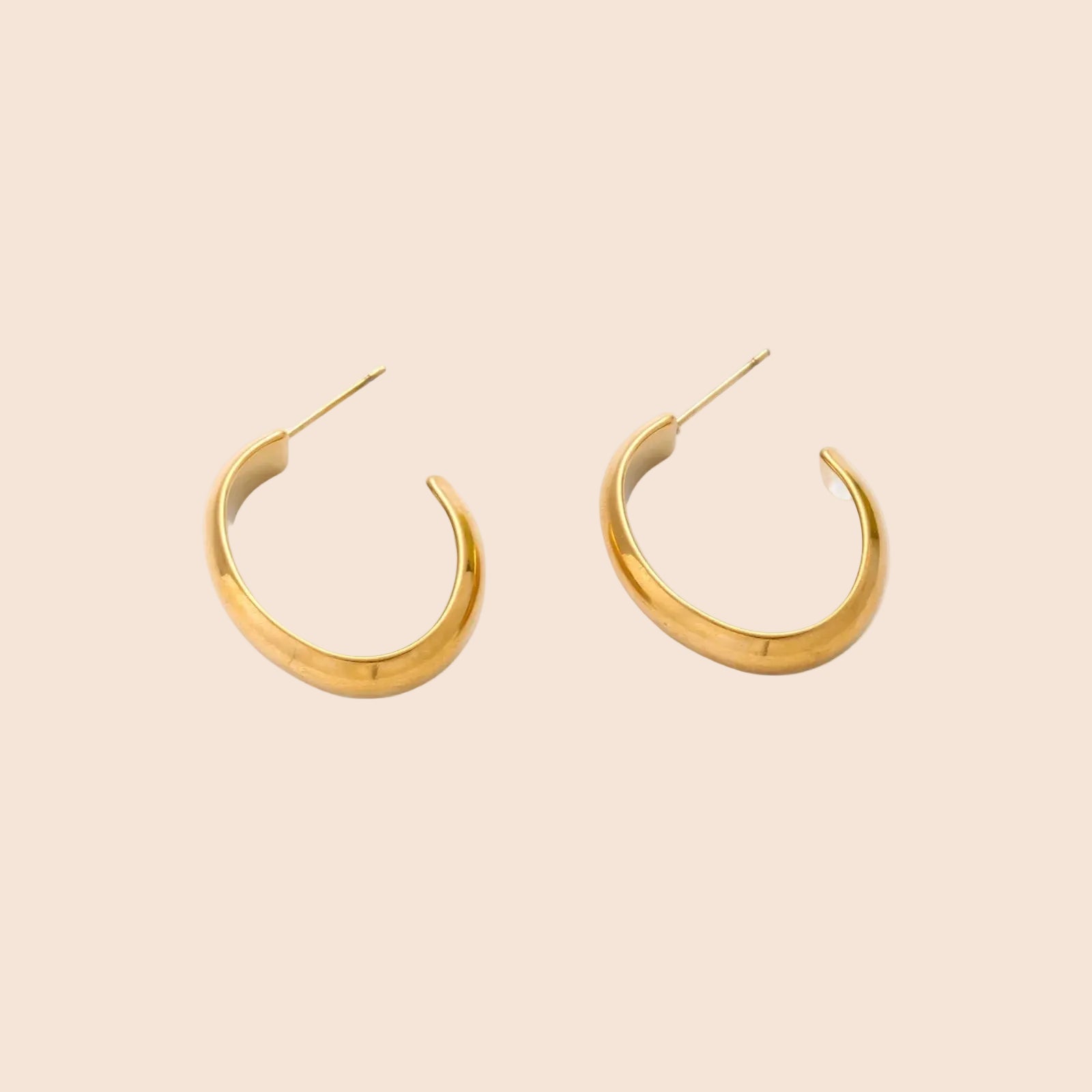 Chunky brushed gold hoop earrings in 14K plated stainless steel on cream background, front and side view.