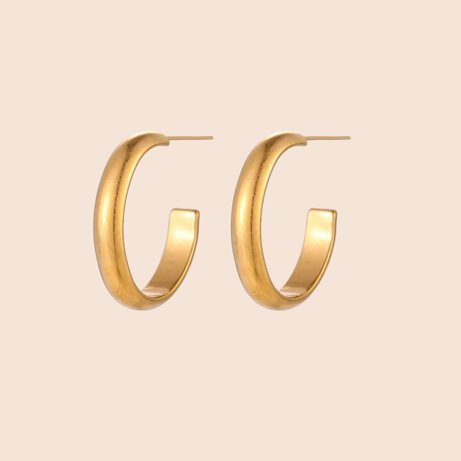 Chunky brushed gold hoop earrings in 14K plated stainless steel on cream background, front and side view.