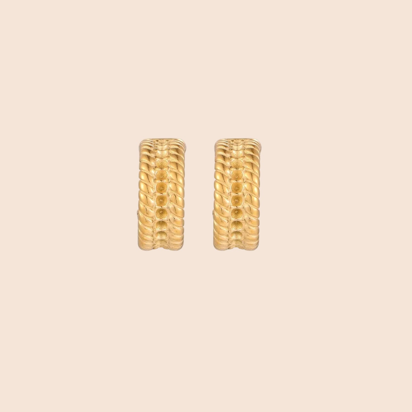 Chunky gold hoops with dimensional ridged texture and 14K plated finish shown in front and side view on cream background.