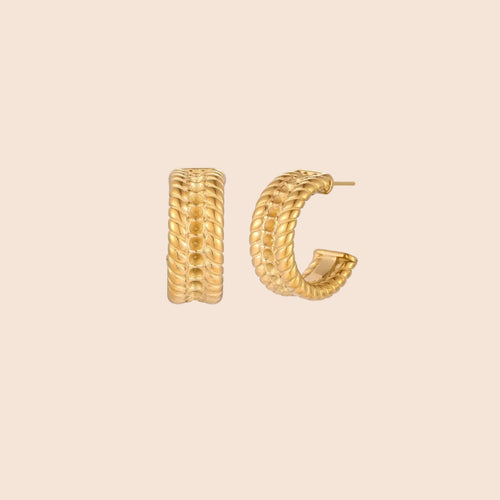 Chunky gold hoops with dimensional ridged texture and 14K plated finish shown in front and side view on cream background.