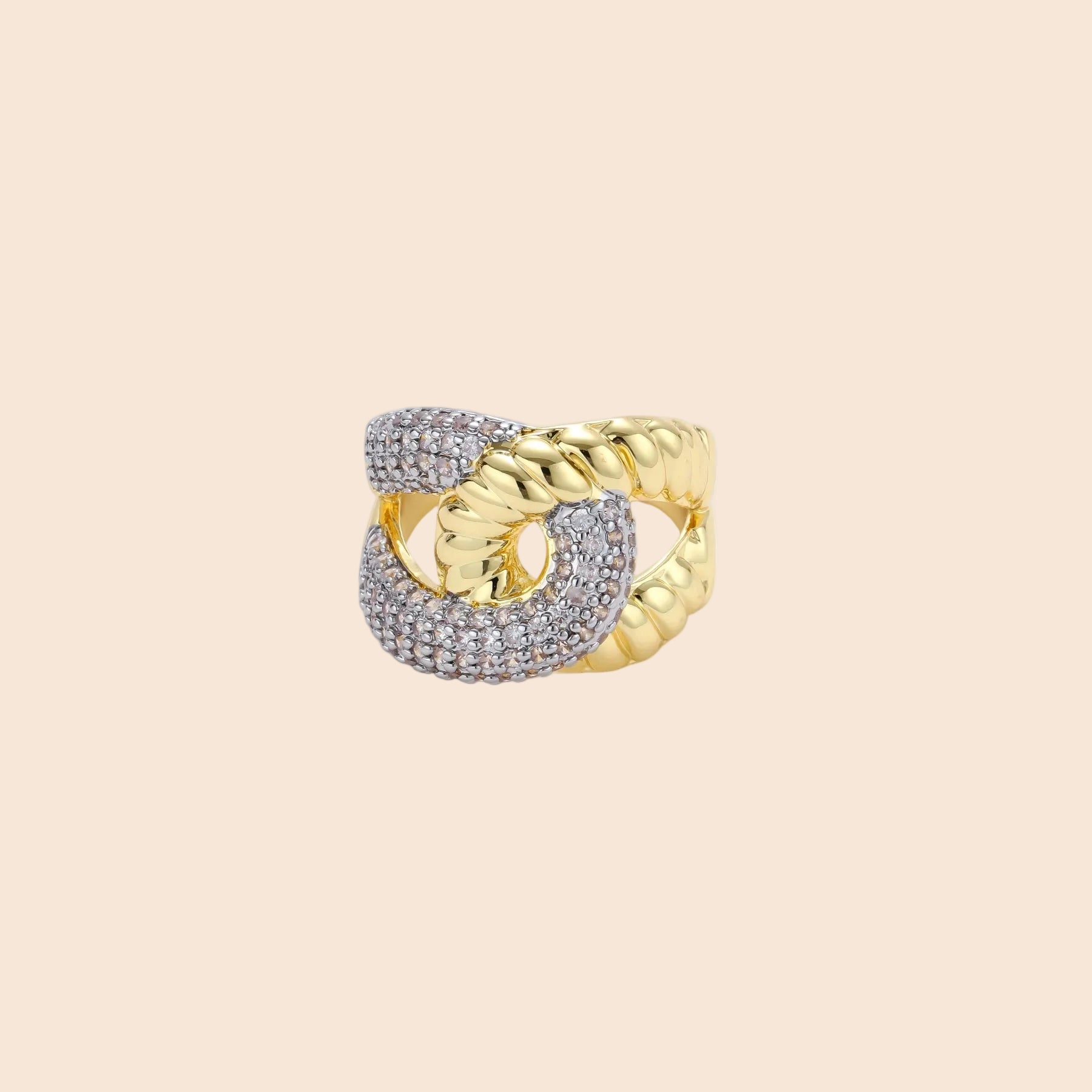 Chunky gold-plated chain-link ring with curved segments and sparkling zirconia crystals on neutral background