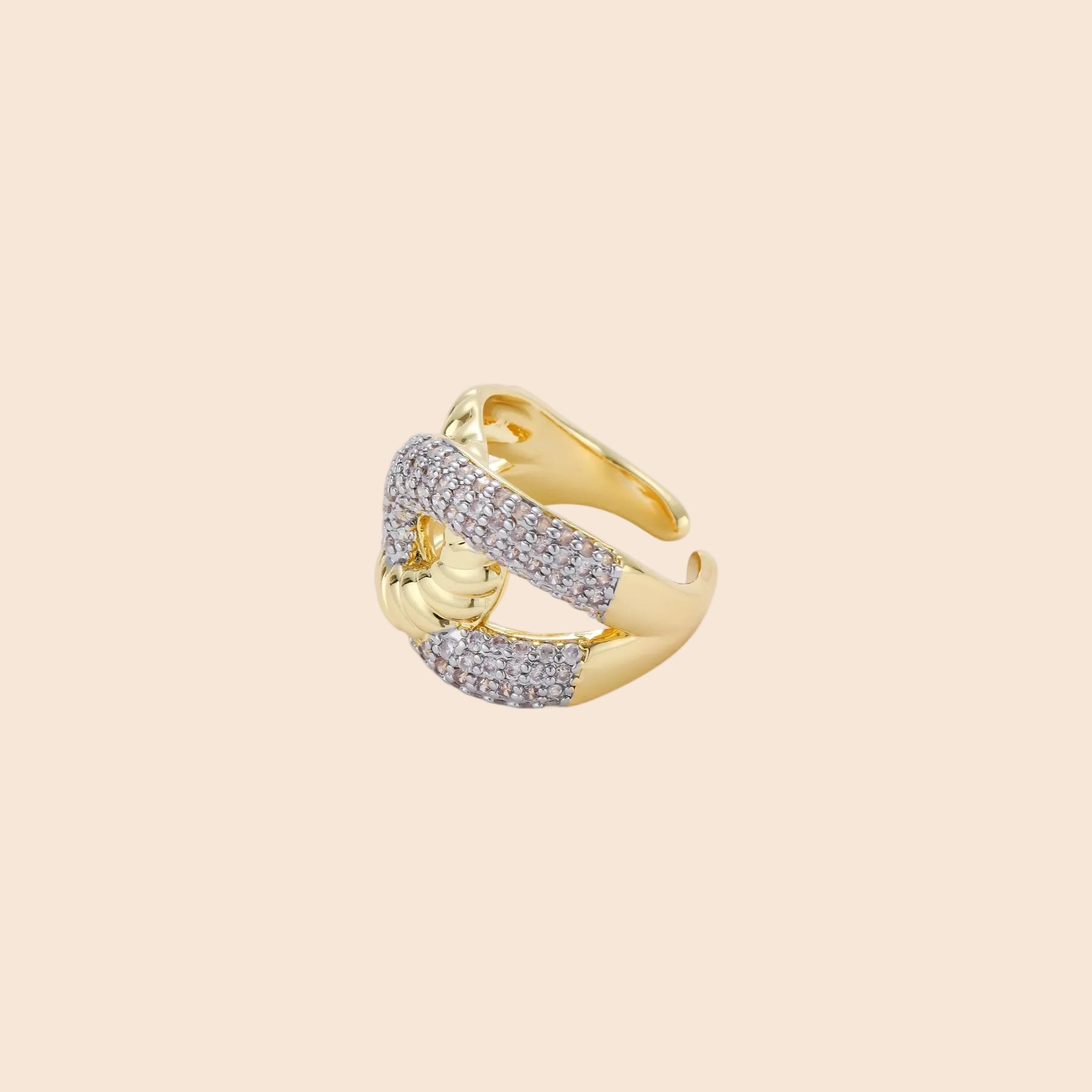 Chunky gold-plated chain-link ring with curved segments and sparkling zirconia crystals on neutral background